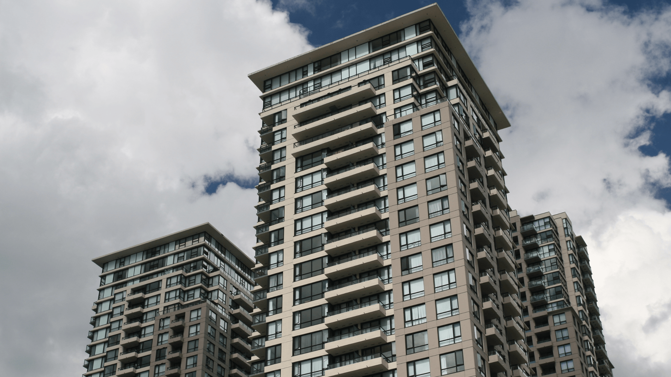 Exterior view of a condominium tower, showing a potential investment property for OFWs looking for rental income