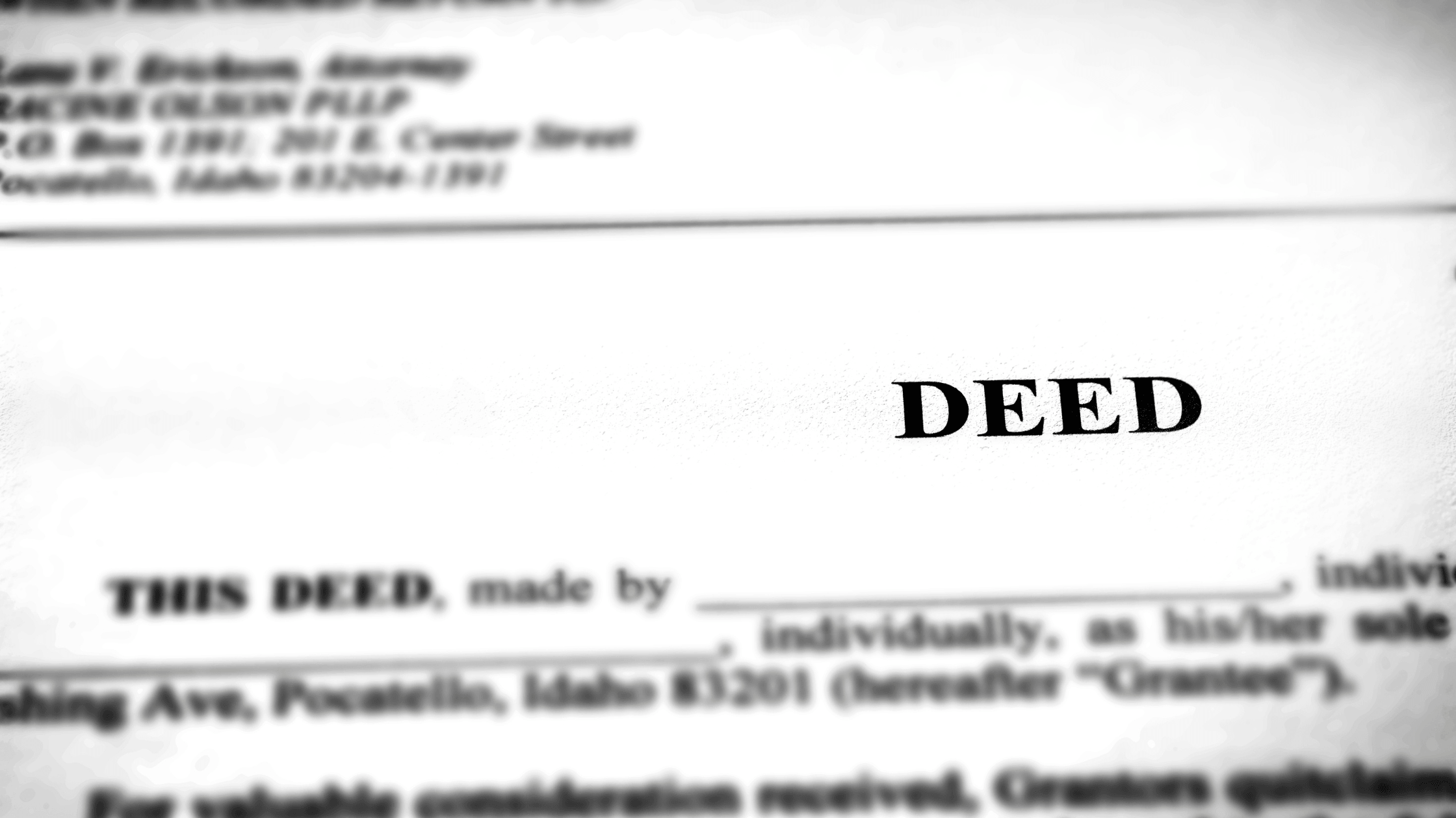 Close-up of a property deed document showing the word 'DEED' at the top, representing the step-by-step process of verifying a land title.