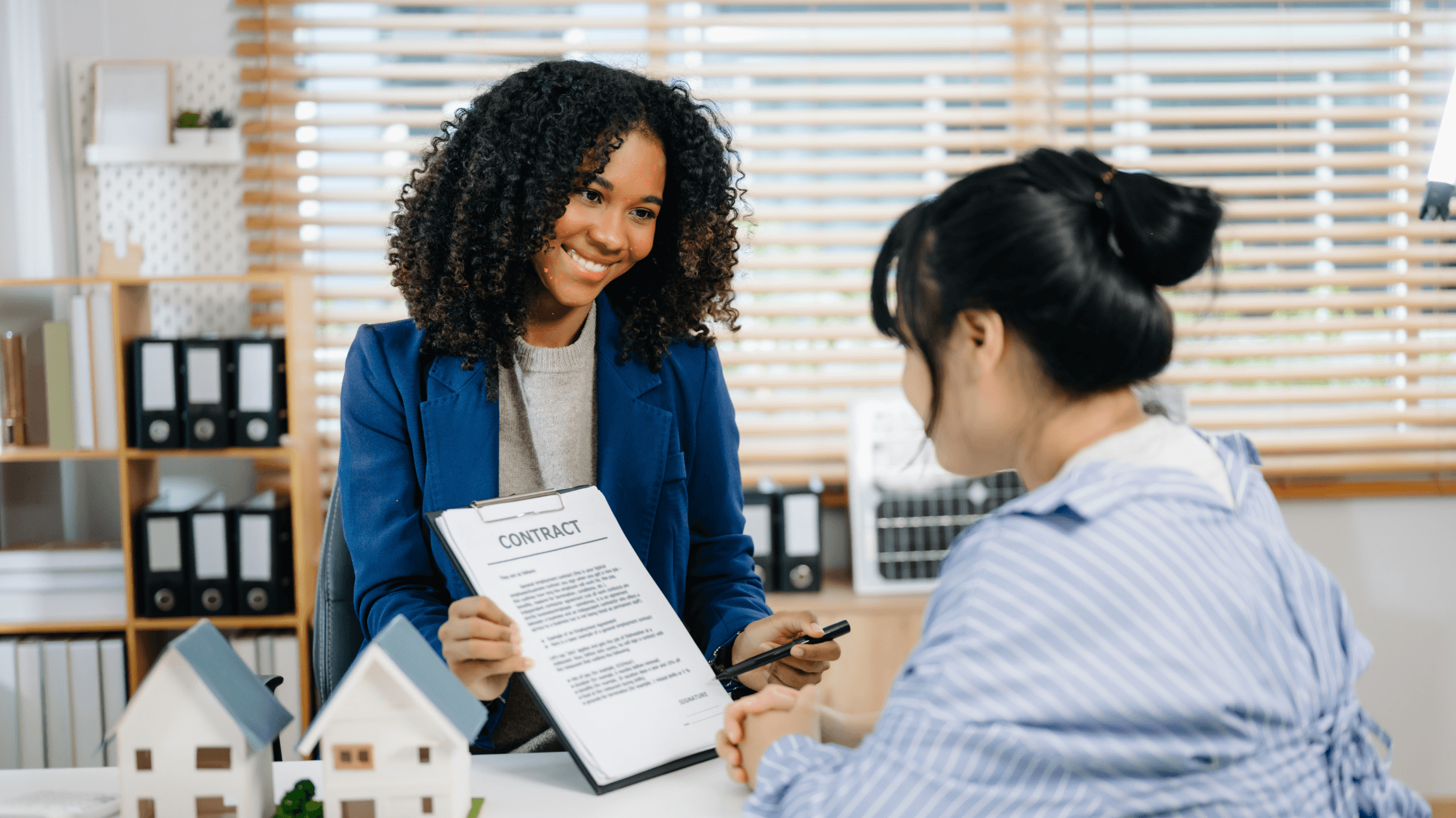 Real estate broker explaining a contract to a client during a property consultation
