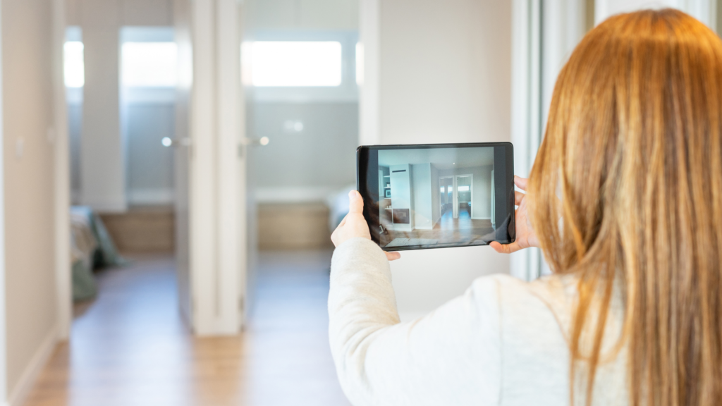 OFW buyer viewing a house interior through a virtual property tour on a tablet.