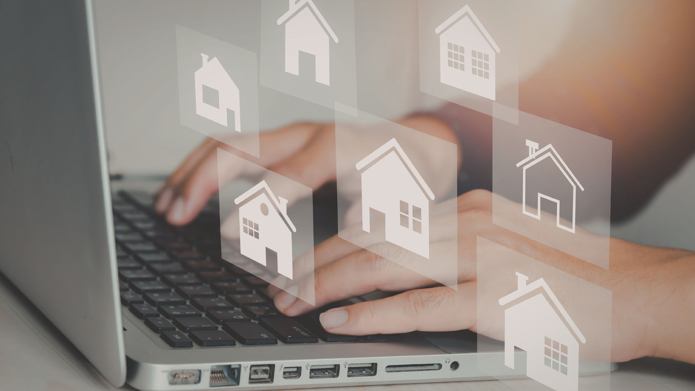 Person searching for real estate listings online using a laptop computer.